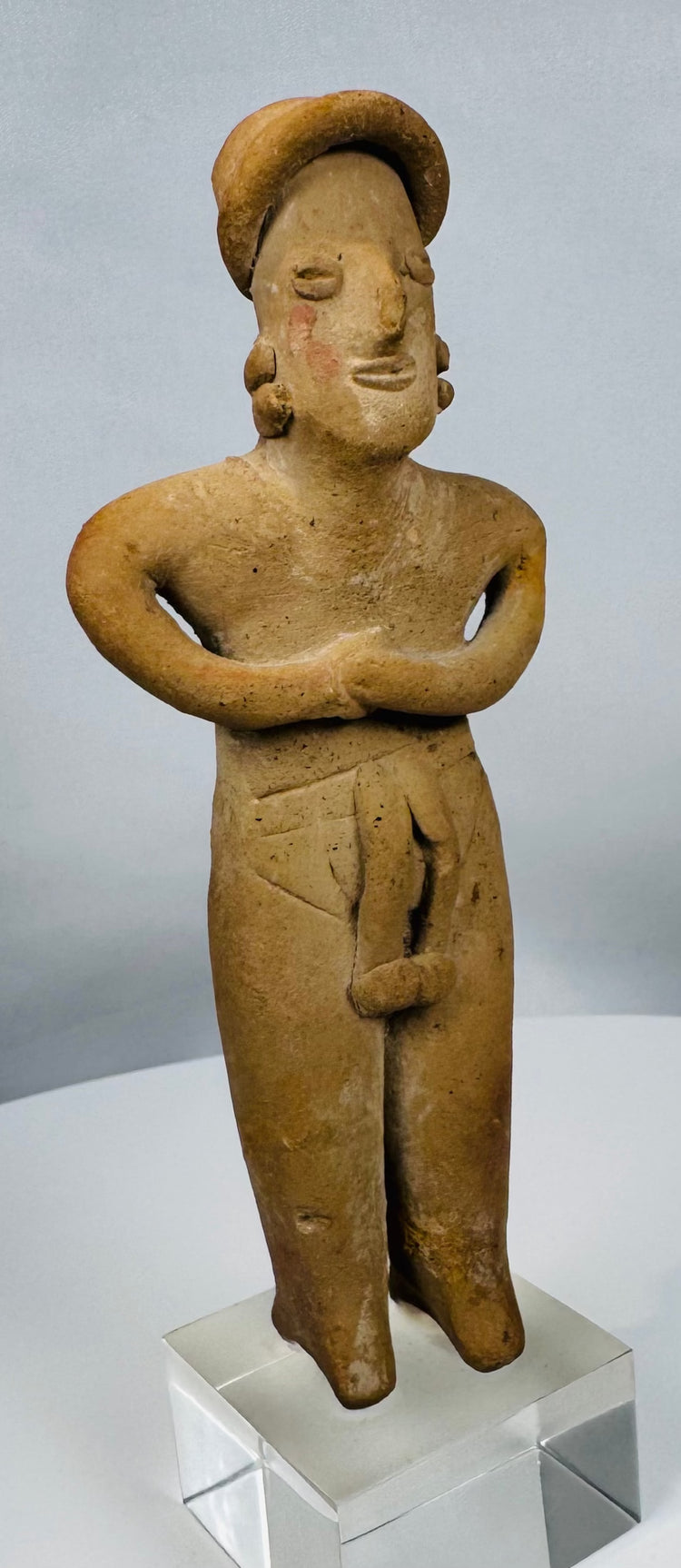Authentic Pre-Columbian female figure from the Colima culture featuring a circular coiffure and earspools.