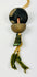 Close-up of ancient bronze bell pendant with original fiber cord and tassel, showing natural verdigris patina and intact upper suspension loop