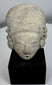 Terracotta human head from the Colima, Jalisco, or Nayarit region mounted on a custom display stand.