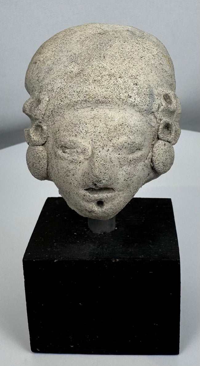Pre-Columbian ceramic effigy head with elongated skull shape and archaeological surface patina.