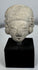 Pre-Columbian ceramic effigy head with elongated skull shape and archaeological surface patina.