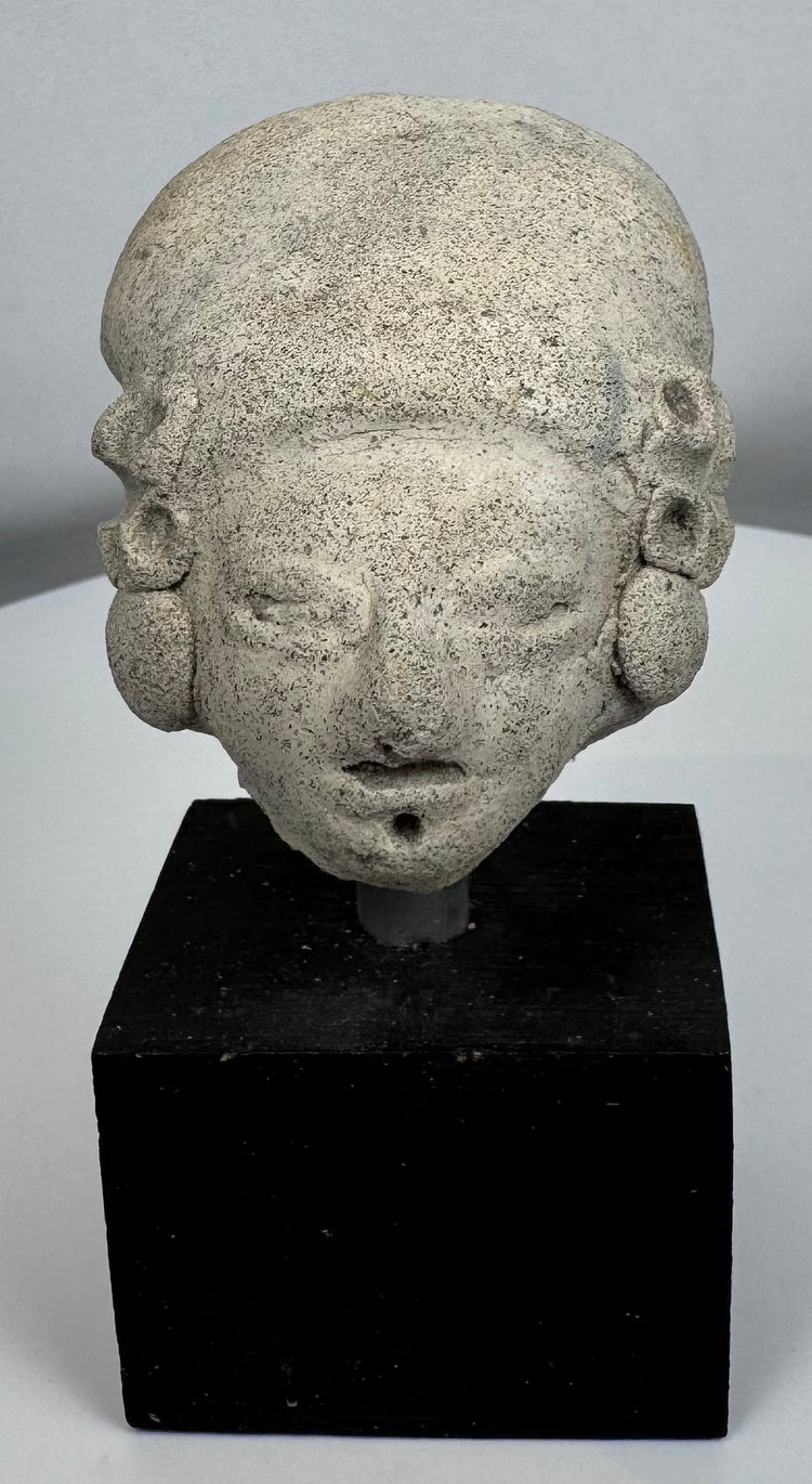 Pre-Columbian ceramic effigy head with elongated skull shape and archaeological surface patina.