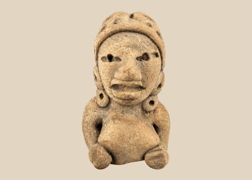 Ancient West Mexican terracotta female figurine, seated with earspools and headdress, hand-modeled with expressive facial features, mounted on a black display base, photographed on a white background.