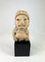 Ancient West Mexican terracotta female figurine with earspools and headdress, seated on display base