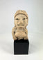 Ancient West Mexican terracotta female figurine with earspools and headdress, seated on display base