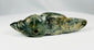 Ancient Pre-Columbian pendant carved from greenstone with symbolic animal form