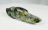 Ancient carved greenstone effigy pendant with elongated tail and drilled eye details
