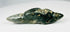 Mesoamerican greenstone pendant featuring reclining animal form and natural patina