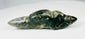 Mesoamerican greenstone pendant featuring reclining animal form and natural patina