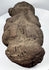 Pre-Columbian volcanic stone effigy with stylized face, folded arms, and seated posture