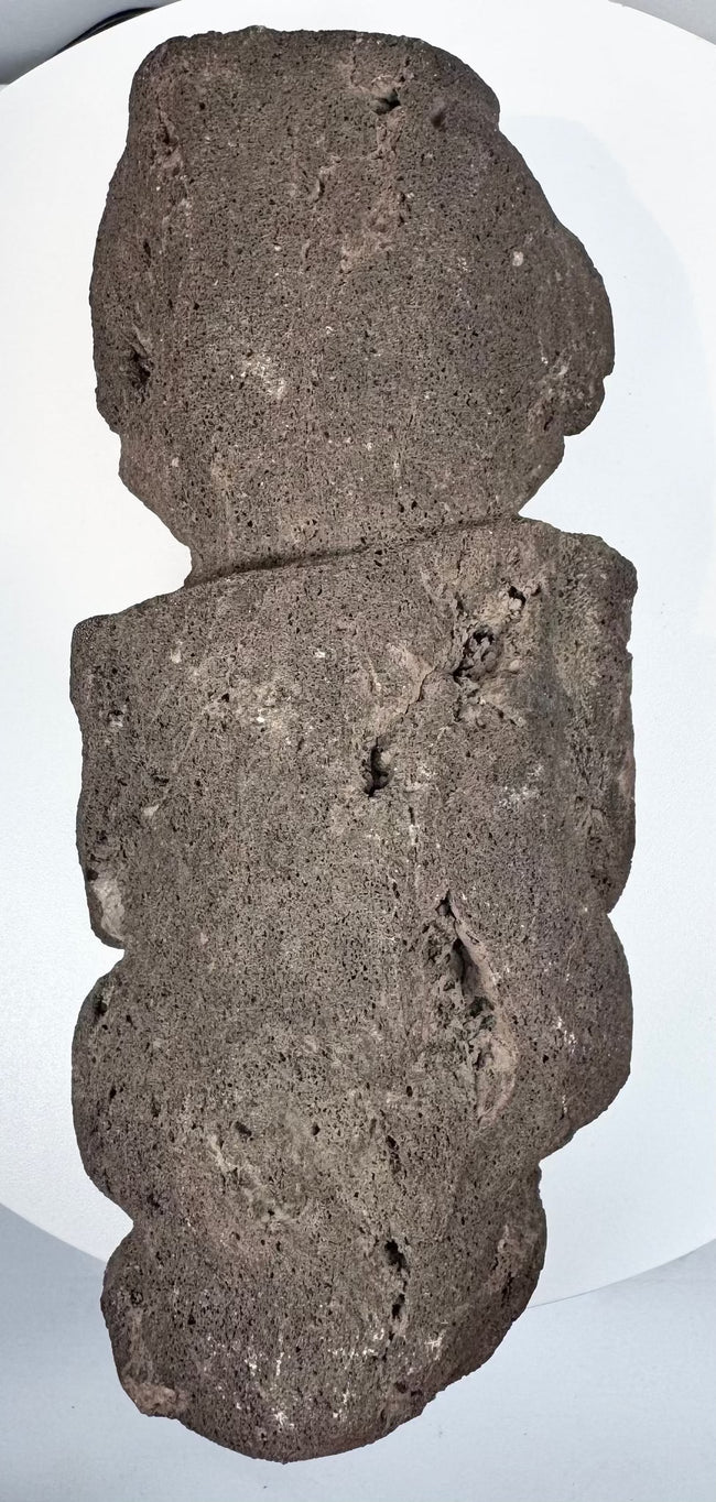 Back view of Pre-Columbian Guerrero stone figure showing flattened reverse and natural volcanic stone texture