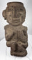 Ancient Mezcala-style stone effigy with geometric head, elongated nose, and compact seated form