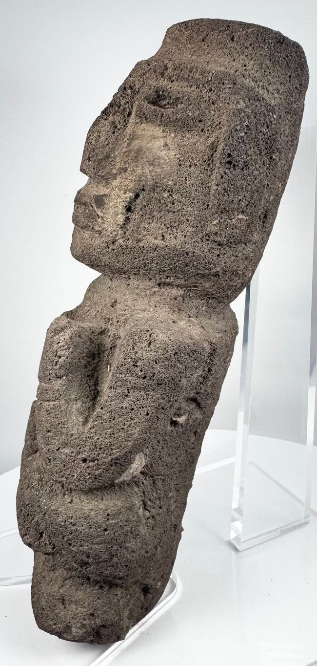 Guerrero stone sculpture depicting an abstract human figure with bent arms and flexed legs