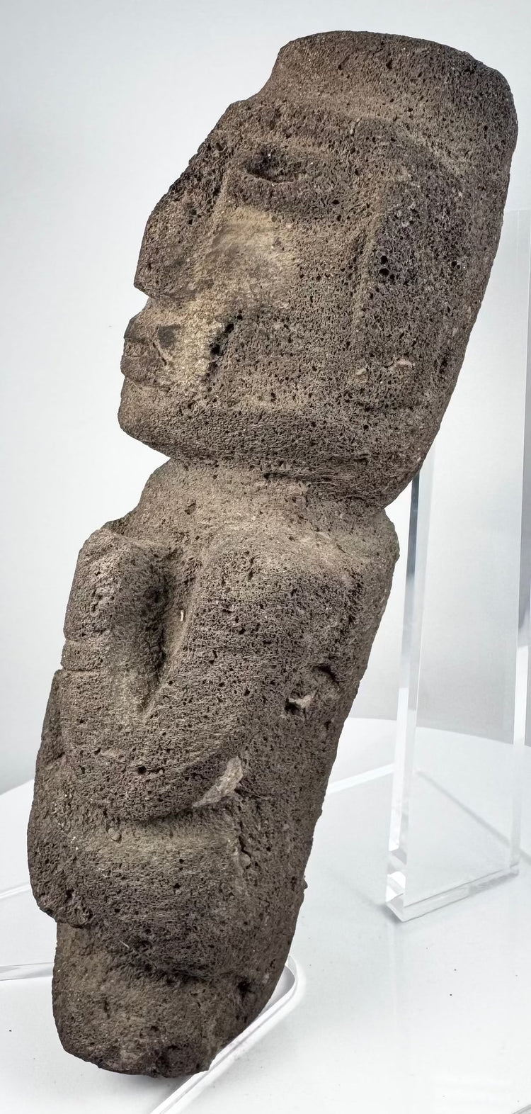 Guerrero stone sculpture depicting an abstract human figure with bent arms and flexed legs