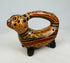 Side profile of polychrome feline effigy vessel with arch handle and ochre-black slip pattern, circa 800–1200 A