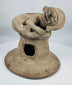 Ancient Ecuadorian terracotta incense burner lid with a sculpted anthropomorphic figure and archaeological patina.