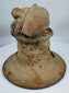 Ancient Ecuadorian ceremonial brazier lid featuring a recumbent figure, large ear ornaments, and vented construction.