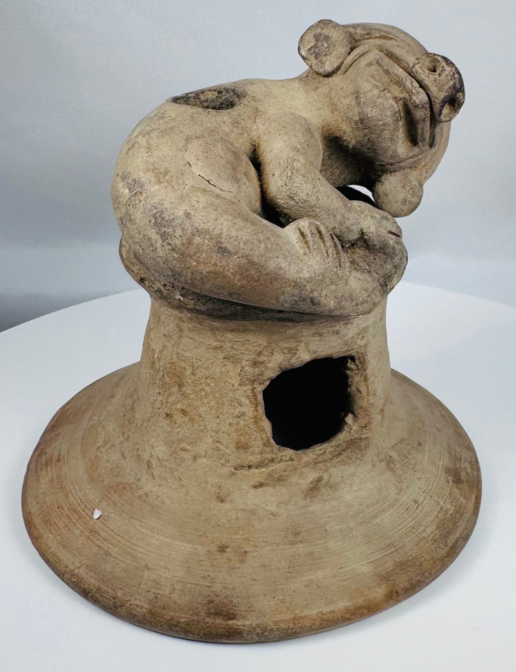 Ancient Manteño terracotta ceremonial vessel lid with stylized human figure and ritual incense vents.