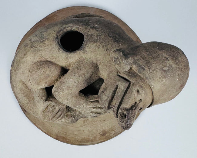 Pre-Columbian Ecuadorian incensario featuring a crouching anthropomorphic figure, vented chamber, and mineral encrustation.