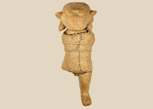 Ancient Pre-Columbian terracotta figurine with stylized facial features and unique headdress, likely Mayan or Zapotec, circa 500–1500 CE.