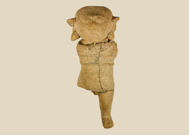 Ancient Pre-Columbian terracotta figurine with stylized facial features and unique headdress, likely Mayan or Zapotec, circa 500–1500 CE.