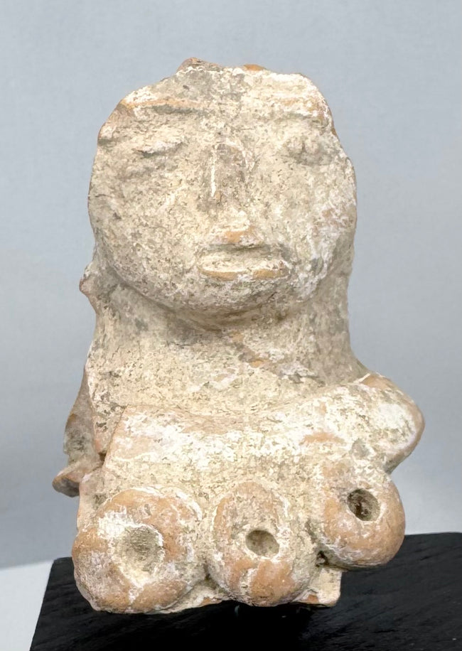 Ancient Mesoamerican terracotta female effigy fragment displaying a large ceremonial headdress and closed eyes.