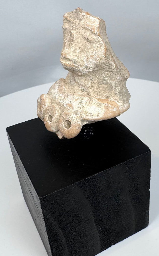 Ancient Mexican terracotta sculpture fragment depicting a female figure associated with fertility and ritual traditions.