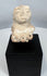 Pre-Columbian terracotta fertility figure fragment with expressive face and surviving upper torso.