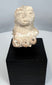 Pre-Columbian terracotta fertility figure fragment with expressive face and surviving upper torso.