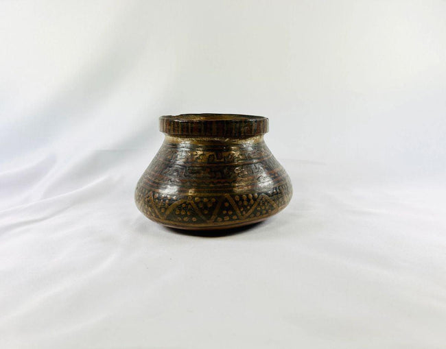 Pre-Columbian Mesoamerican pottery vessel showing painted polychrome patterns and rounded body shape.
