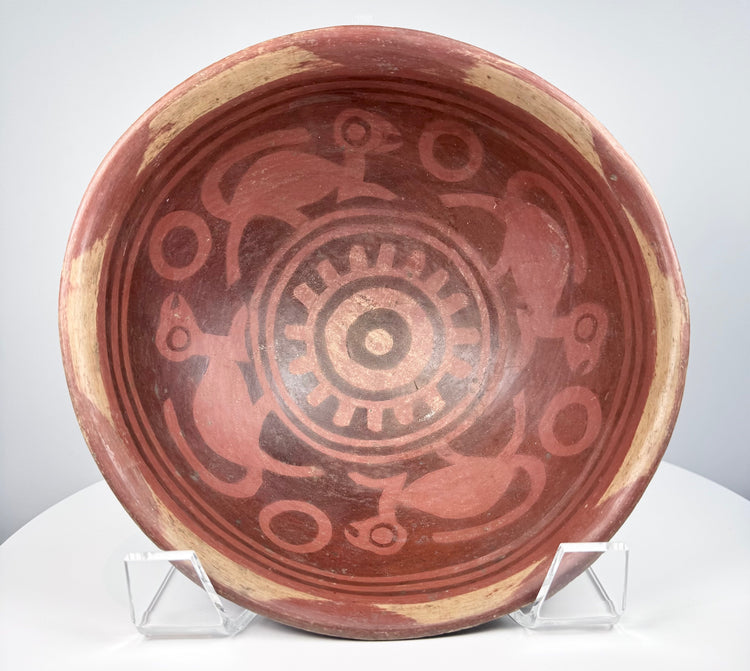 Pre-Columbian Nariño ceramic vessel with painted interior decoration, stylized monkeys, and patterned rim border.