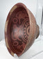Ancient Nariño terracotta bowl featuring four stylized monkey motifs and geometric negative resist decoration.