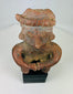 Close-up of terracotta headdress and facial detailing on Nayarit seated figure.