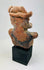 Rear view of Pre-Columbian Nayarit figure showing headdress and back surface wear.