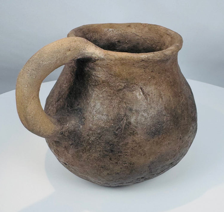 Authentic Casas Grandes earthenware mug with flared rim, globular form, and mineral deposits acquired through centuries of burial.