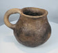 Historic Paquimé pottery vessel from Chihuahua, Mexico, displaying hand-formed construction and a well-executed strap handle.