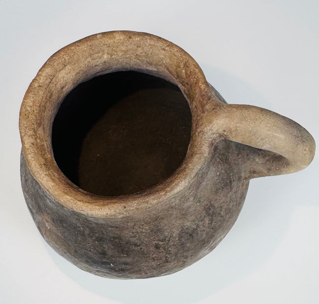Ancient Casas Grandes utilitarian pottery vessel with natural burial patina, rounded form, and traditional ceramic construction.