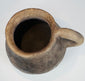Ancient Casas Grandes utilitarian pottery vessel with natural burial patina, rounded form, and traditional ceramic construction.