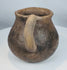Ancient northern Mexican pottery mug from the Paquimé culture featuring a smooth earthenware surface and functional utilitarian design.