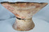 Archaeological Pre-Columbian terracotta bowl featuring painted triangular designs and visible age-related wear.