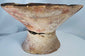 Archaeological Pre-Columbian terracotta bowl featuring painted triangular designs and visible age-related wear.