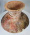Antique terracotta pedestal bowl displaying traditional painted motifs, mineral deposits, and historic repairs.