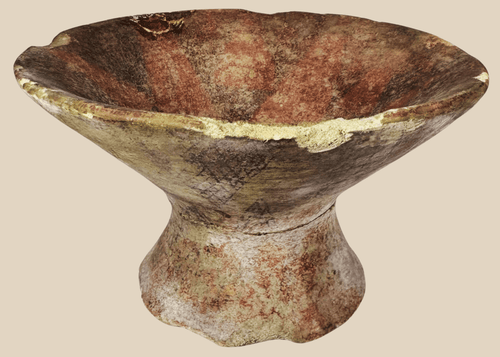 Pre-Columbian terracotta pedestal bowl with painted geometric motifs in red, cream, and dark brown pigments.