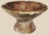 Pre-Columbian terracotta pedestal bowl with painted geometric motifs in red, cream, and dark brown pigments.