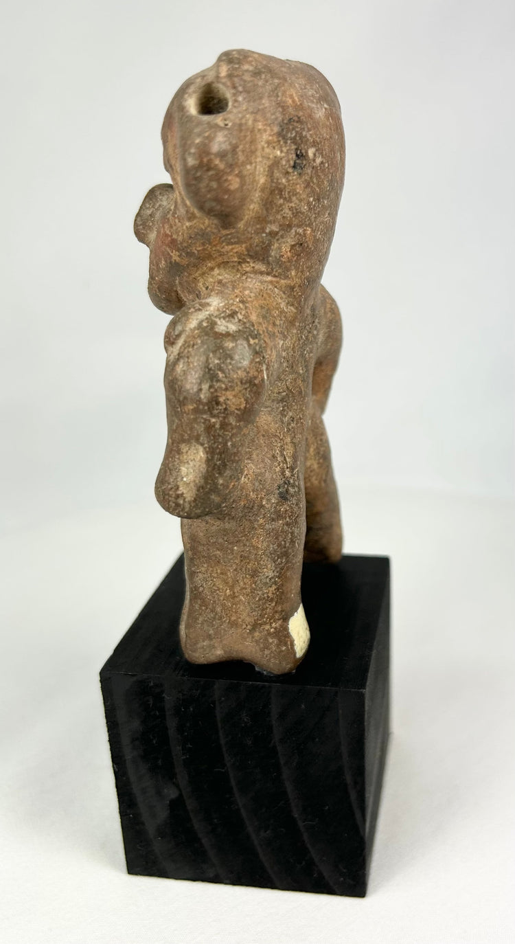 West Mexican terracotta tomb figure featuring a large stylized head and pierced ears