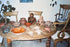 Archival collection photograph showing Pre-Columbian terracotta figures, Sonriente heads, ceramic vessels, and a West Mexican tripod bowl displayed together.