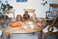 Archival collection photograph showing Pre-Columbian terracotta figures, Sonriente heads, ceramic vessels, and a West Mexican tripod bowl displayed together.