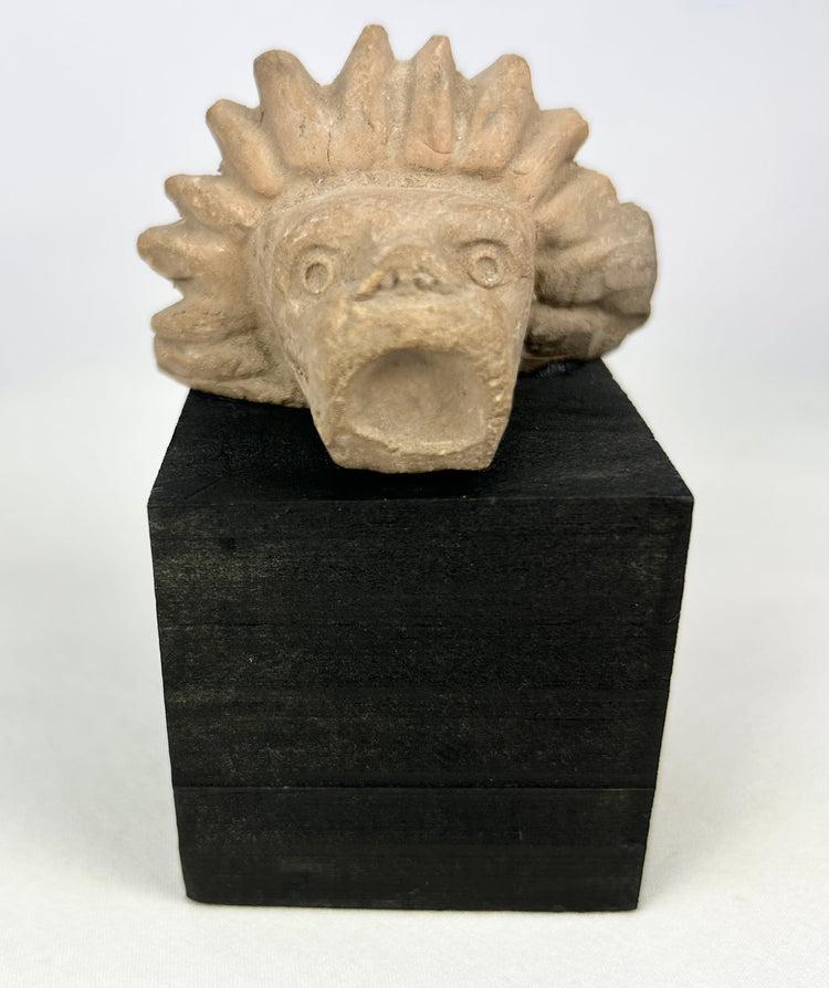 Ancient stone animal head sculpture fragment with jaguar-like features