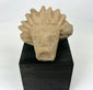 Pre-Columbian Mesoamerican stone head fragment mounted for museum-style display