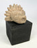 Mesoamerican architectural stone fragment featuring stylized animal head carving